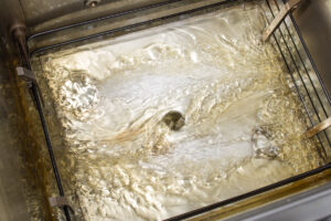 Filtering Fryer Oil with Henny Penny built-in filtration.