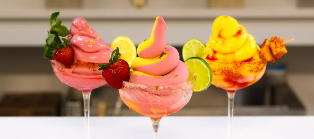Strawberry and mango soft serve margarita in a coupe glass — spring 2026 cocktail trend
