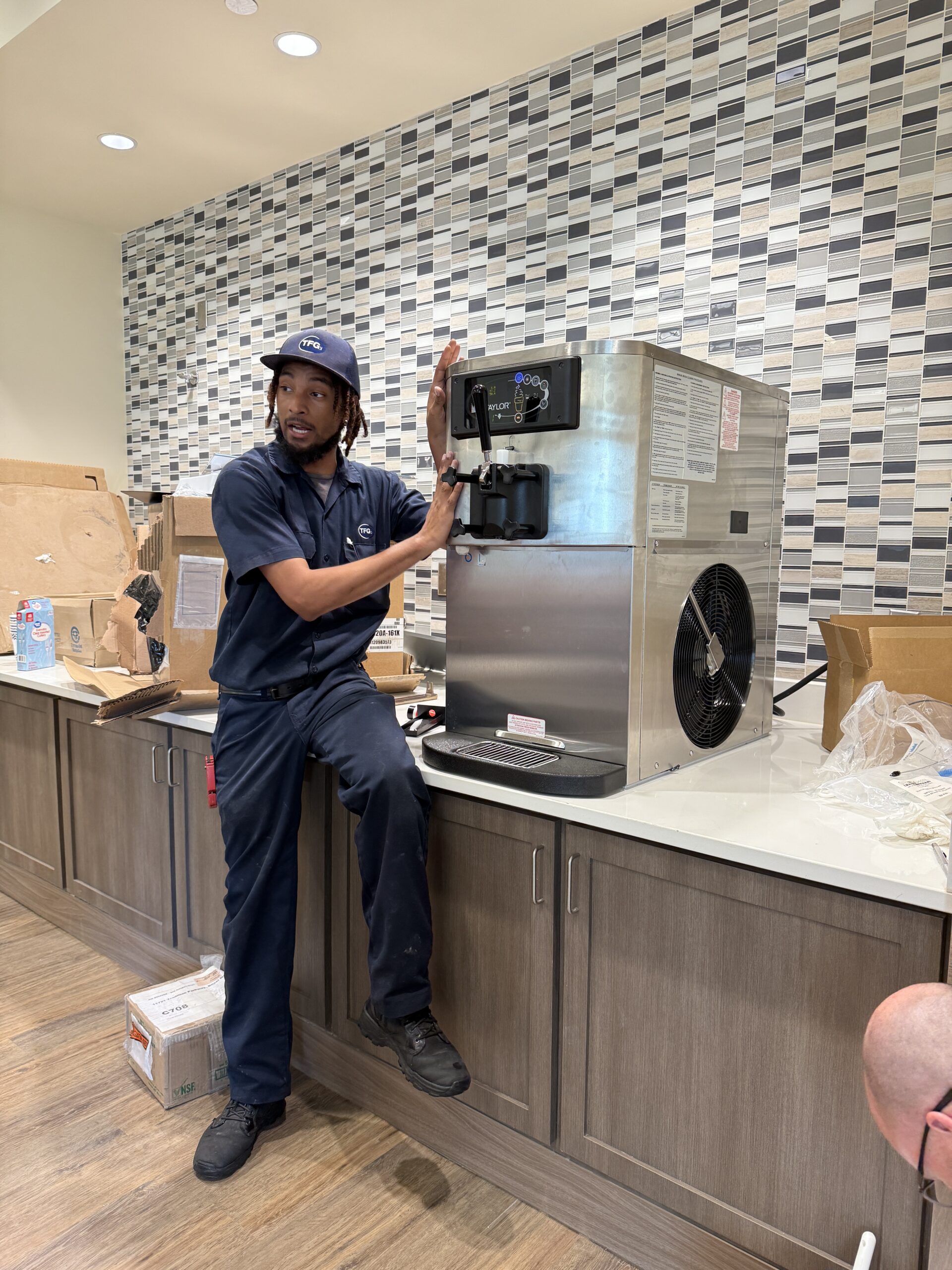 TFG technician installing and commissioning a soft-serve machine at a customer location