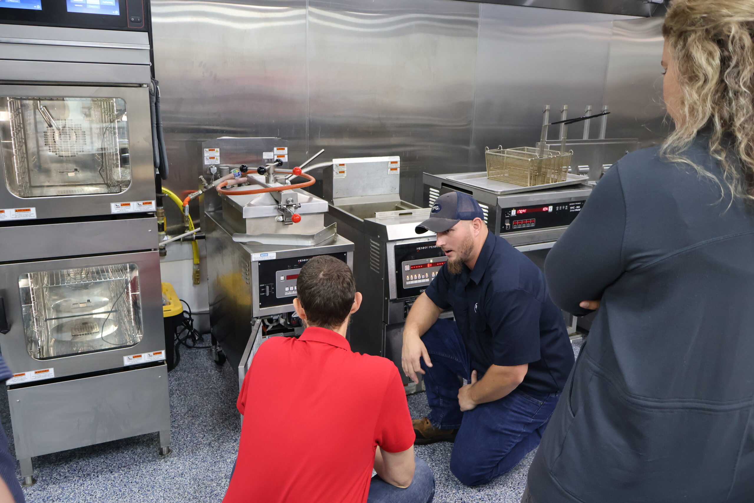 TFG factory-trained technician demonstrating commercial fryer operation to foodservice staff
